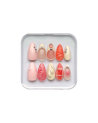 Set of press on nails in orange, pink, pale yellow, and pale pink in a clear plastic case on a white background. Silver and pearl detailing. 